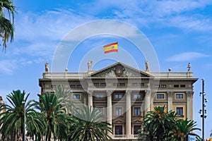 Military Government of Barcelona neoclassical building - Gobierno Militar de Barcelona -with Spanish flag waving on top in photo