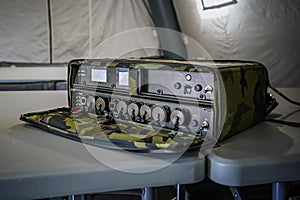 Military grade ruggedized ethernet network switch on a desk in army tent, closeup detail