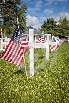 Military grave markers decorated with American flags for Memorial Day in the United States