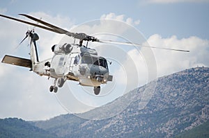 Military helicopter above hills