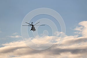 Military helicopter in flight in blue sky