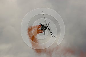 Military helicopter in flight, smoke