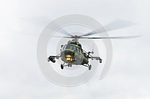 Military helicopter flying against the cloudy sky