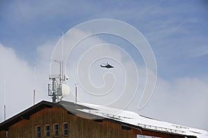 Military helicopter. Italian military helicopter in the sky. Military helicopter against the background of a blue sky.