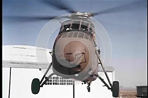 Military helicopter landing on helipad