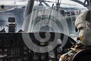 Military helicopter pilot operate in navy aircraft cabin at army base