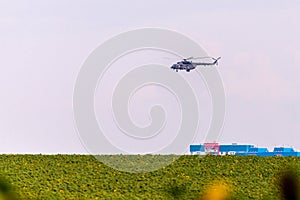 Military helicopter takes off from the field