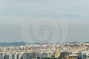 Military helicopters flying above a city. photo