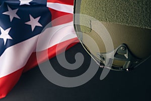 Military helmets and American flag on background