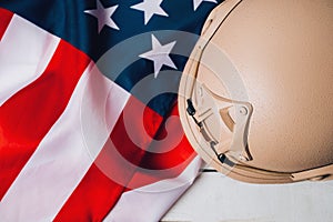 Military helmets and American flag on background