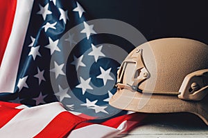 Military helmets and American flag on background