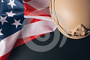 Military helmets and American flag on background