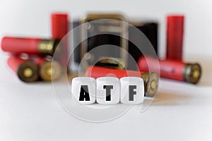 Against the background of cartridges and a military belt, cubes with the inscription - ATF photo