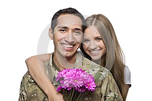 Military Husband and Wife Smile with Flowers photo
