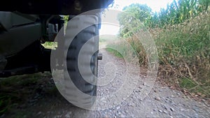 Military jeep 4x4 car driving on dirt road, close up of wheel