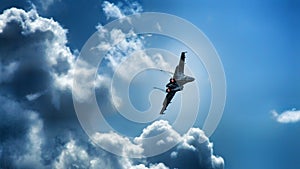 Military jet aircraft during turn into clouds.