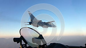 Military jet bomber Su-24 Fencer flying above the clouds