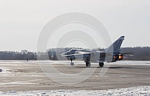 Military jet bomber Su-24 Fencer afterburner takeoff photo