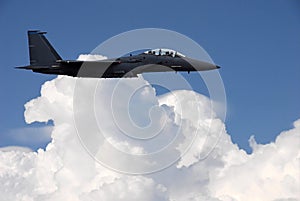 Military jet flying above the clouds