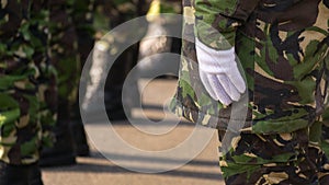 Military man hands putting on some white gloves