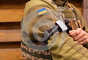 A military man holds a medical tourniquet in his hands to stop blood in first aid and prevent bleeding.