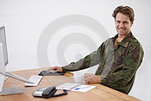 Military man in office, research at desk and smile in portrait with army operation and gather intelligence online. Young photo
