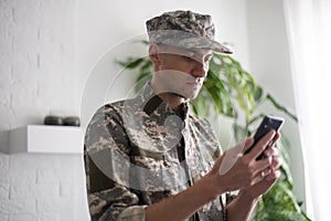 military man with phone, cyber police, information war