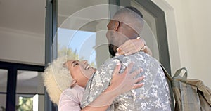 Military man reunites with partner, evoking joy and relief.