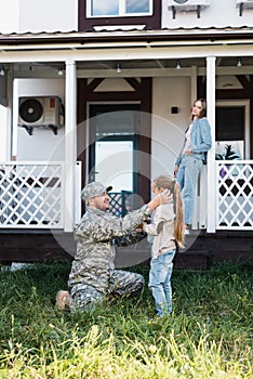 Military man sitting on knee and