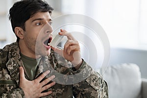 Military man suffering from panic attack, using inhaler