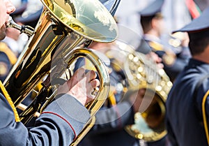 Military musician with brass tuba at street concert