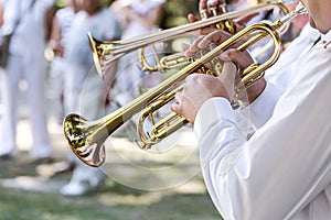 Military musicians playing on trumpets in army brass band