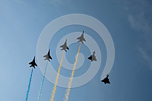 Military parade of 30 years Independence Day of Ukraine. Black silhouettes of six aircrafts flying with color smoke