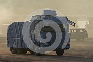 Military police vehicles enforcing law and order in protest, war, and conflict driving across the desert