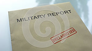 Military report declassified, seal stamped on folder with important documents photo