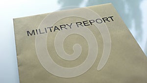 Military report, folder with important documents lying on table, close up