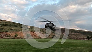 Military rescue helicopter taking off at the countryside