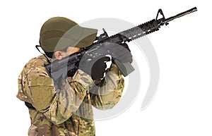 Military serviceman pointing riffle up