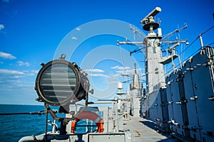 Military ship search light on the deck