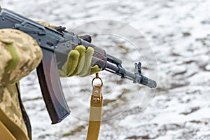 A military soldier in camouflage with a weapon goes on the offensive in winter