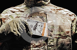 MIlitary soldier putting money in his pocket