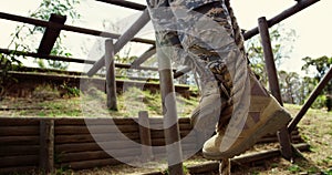 Military soldiers climbing rope during obstacle course 4k