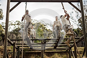 Military soldiers training rope climbing