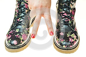 Military style boots with flowers decoration on an hands with po