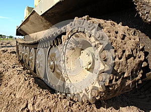 Military tank caterpillar, mudded.