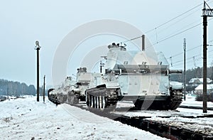 Military tanks transported on platforms by rail