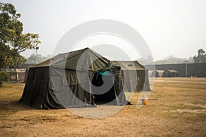 Military tent in the field. big tent city. field camp in nature. military base with temporary barracks. military exercises of the