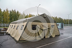 Military tent. Military base with temporary barracks. Exercises of the soldiers. Army camp.