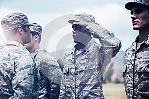 Military trainer giving training to military soldier