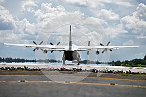 Military transport aircraft landing on runway
